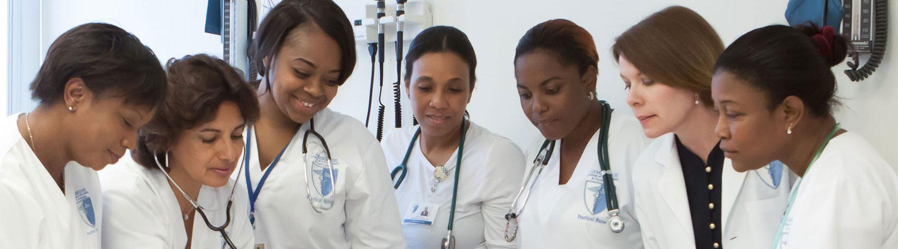 female nursing students watching instructor use stethoscope