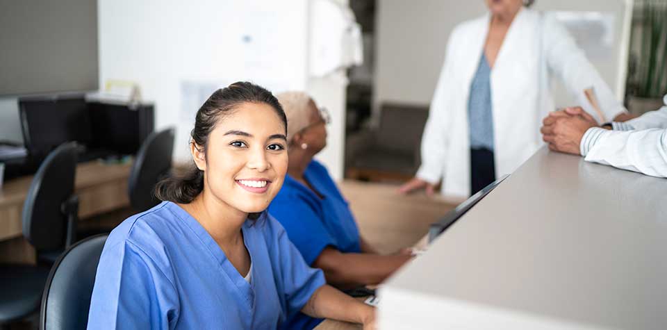 A female medical assistant is in the office