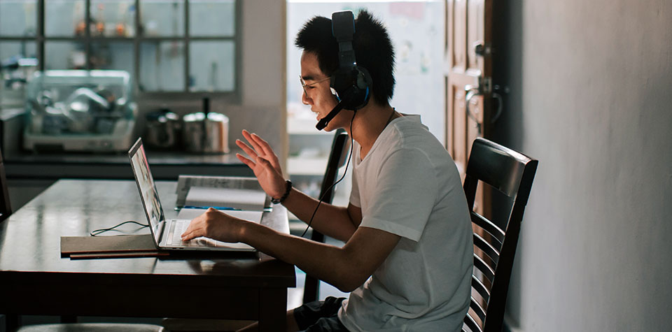 A male student is studyiing in computer networking