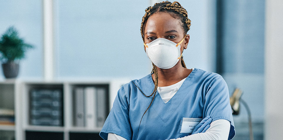 Young female medical assistant wearing a mask
