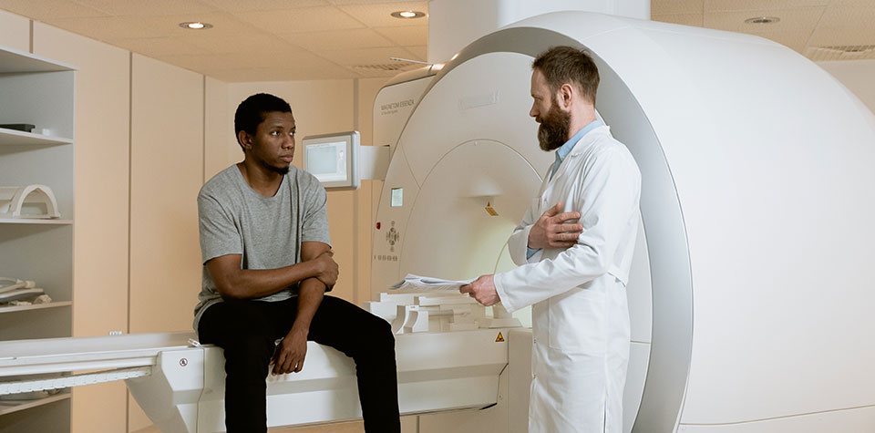 a radiation therapist is speaking with a patient