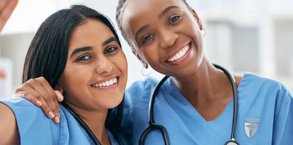 Two female nursing students are posing for a picture