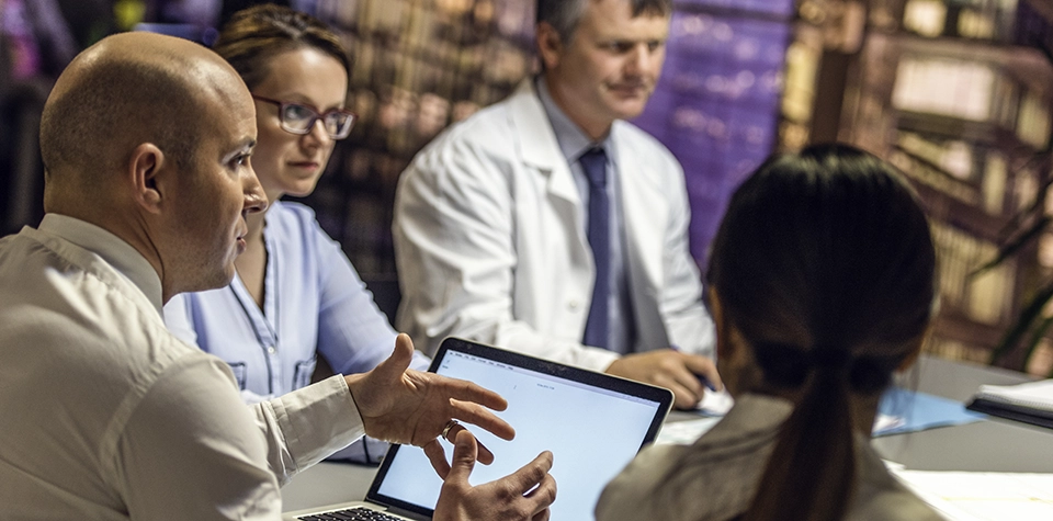 Healthcare Law and Ethics leadership professionals are gathered around in a meeting regarding healthcare law